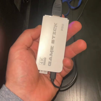 RetroStick Pro i hånden, klar til å settes i TV-en